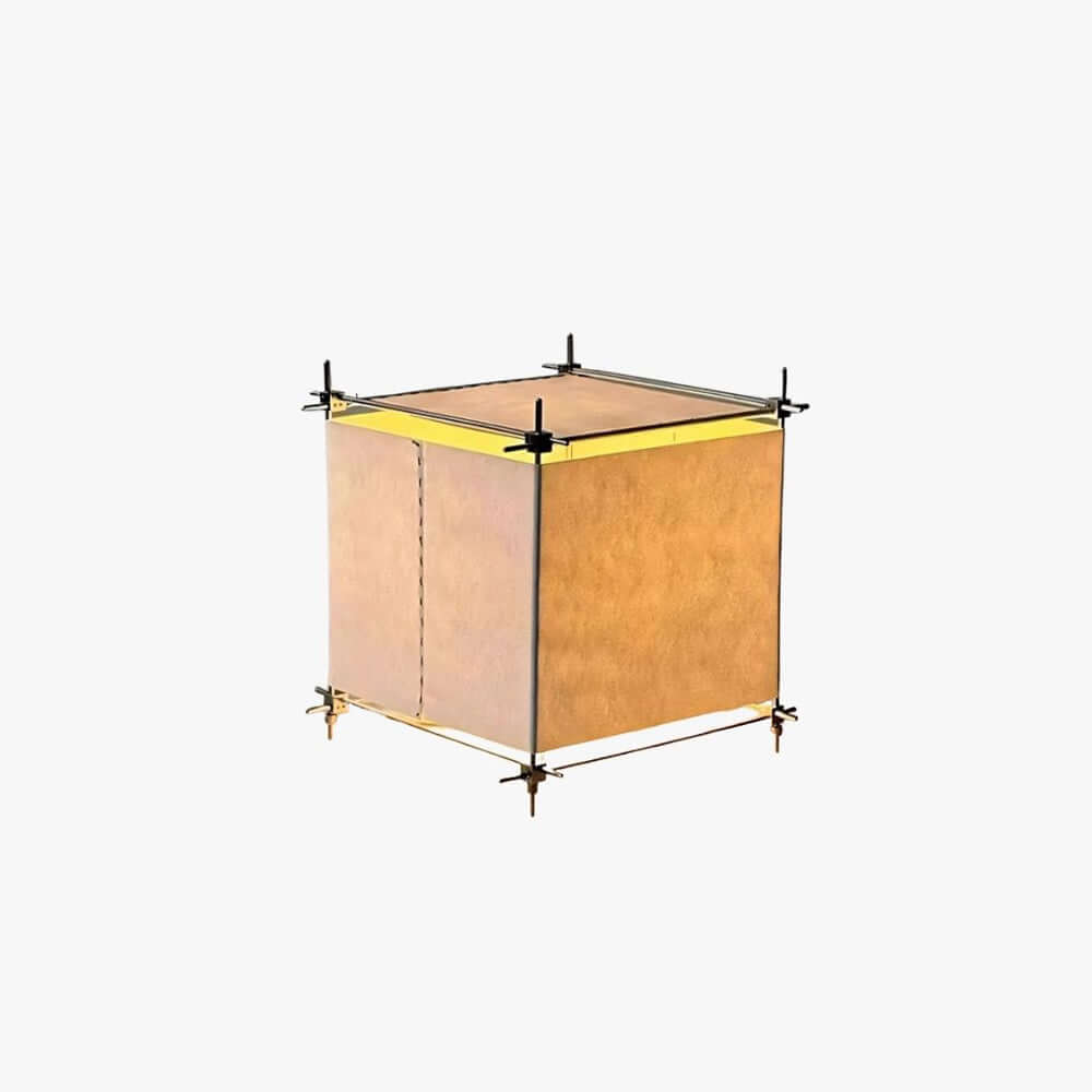 Unlit Clérachic table lamp on a white backdrop, a cube of parchment panels held in a slim metal frame with dark corner joints.