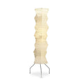 A Clérachic tall washi paper floor lamp on a white background, its creased pale shade on three thin black iron legs.
