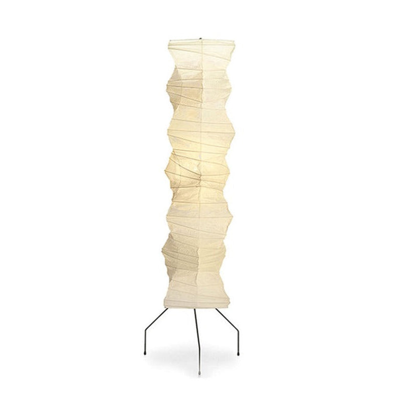 A Clérachic tall washi paper floor lamp on a white background, its creased pale shade on three thin black iron legs.