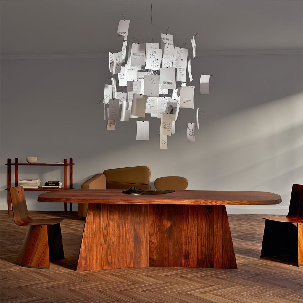 Hung over a walnut dining table in a grey room, this Clérachic pendant is a cloud of handwritten paper notes.