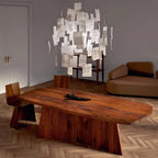 Hung above a low walnut table in a bright room, this Clérachic paper pendant looks like a cloud of white notes.