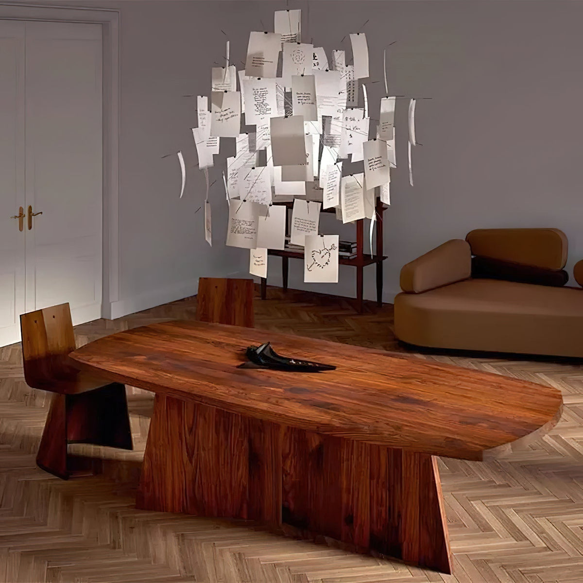 Hung above a low walnut table in a bright room, this Clérachic paper pendant looks like a cloud of white notes.
