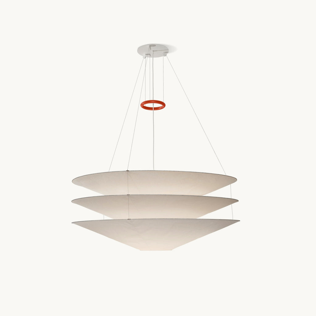 This Clérachic pendant has three stacked white paper cones hung on fine cables, with a red ring above, on a plain white backdrop.