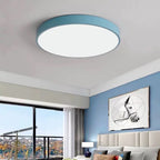 This powder-blue Clérachic flush mount ceiling light lights a serene bedroom with a horse print above the bed.