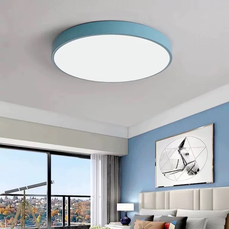 This powder-blue Clérachic flush mount ceiling light lights a serene bedroom with a horse print above the bed.