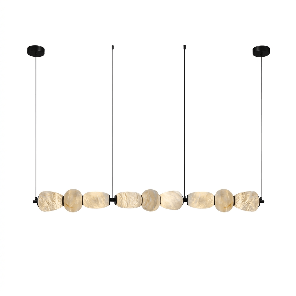 Clérachic gallery view of nine flat stone pebbles in a line, hung from two black canopies and fine cords, on a plain white background.