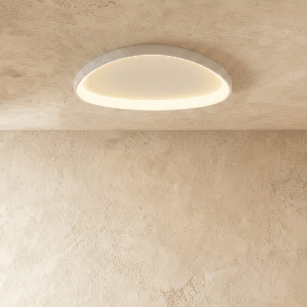 Clérachic larger white aluminium ceiling light, flush-mounted and glowing evenly against a textured limewash ceiling.