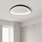 Clérachic single black oval ceiling light glowing warm in a bedroom with a sheer curtain and a bright window.