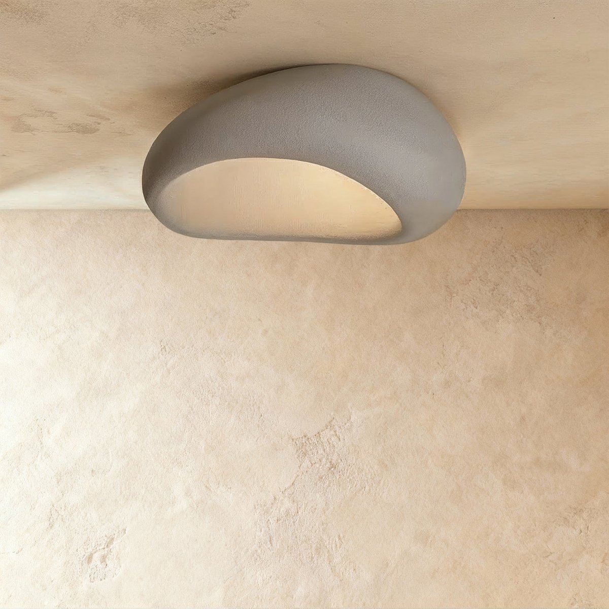 Clérachic wide grey pebble ceiling light with a fine matte texture and a pale, evenly glowing opening.