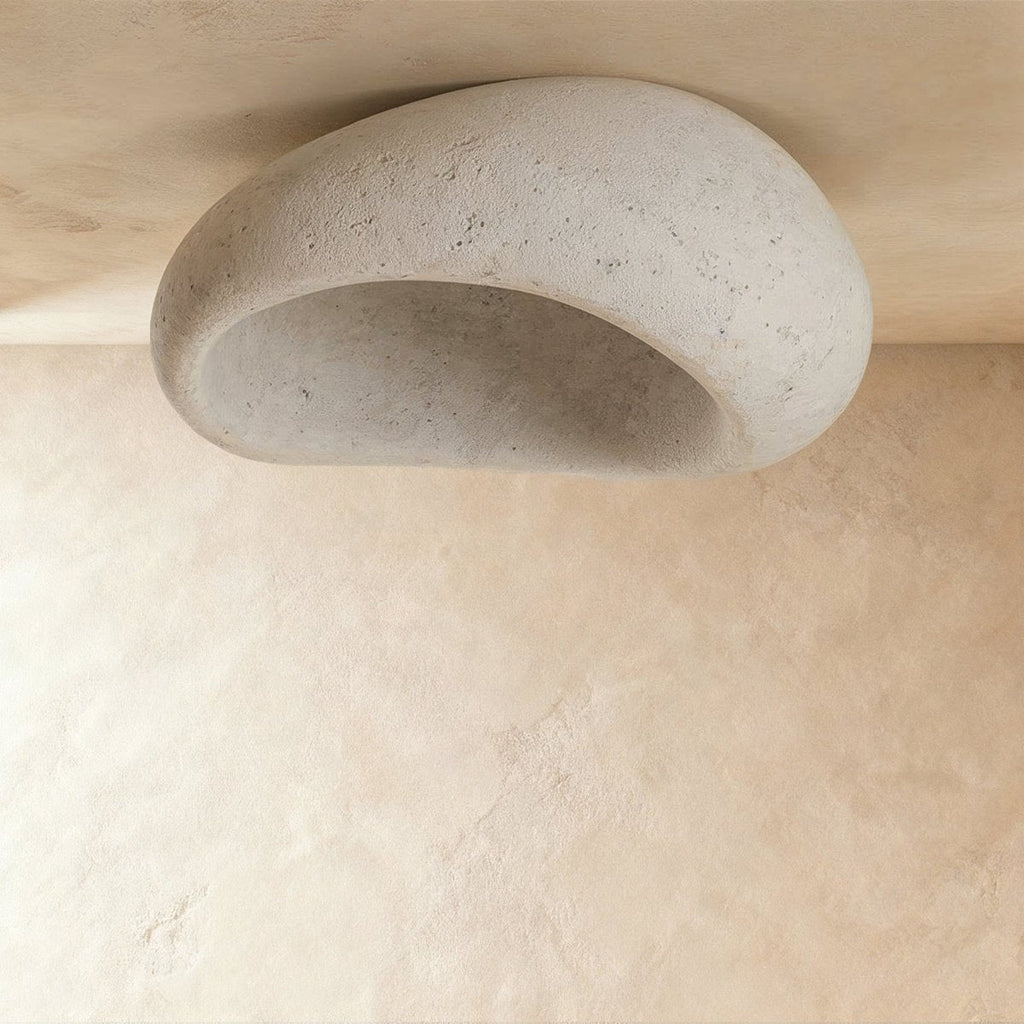 Clérachic large pebble ceiling light in speckled cement white, shown unlit to reveal the hollow, stone-like interior.