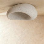 Clérachic large pebble ceiling light in speckled cement white, shown unlit to reveal the hollow, stone-like interior.