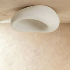 Clérachic large white pebble ceiling light shown unlit, with a smooth textured shell and a pale hollow interior.