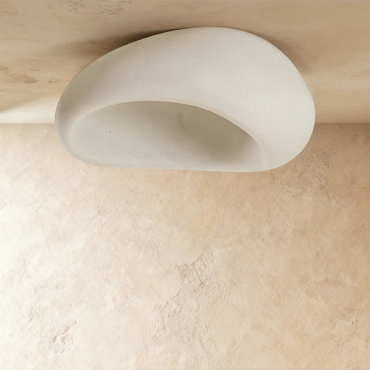Clérachic large white pebble ceiling light shown unlit, with a smooth textured shell and a pale hollow interior.