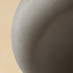 Close detail of the Clérachic grey shell, showing its fine matte grain and subtle pitting along the curve.