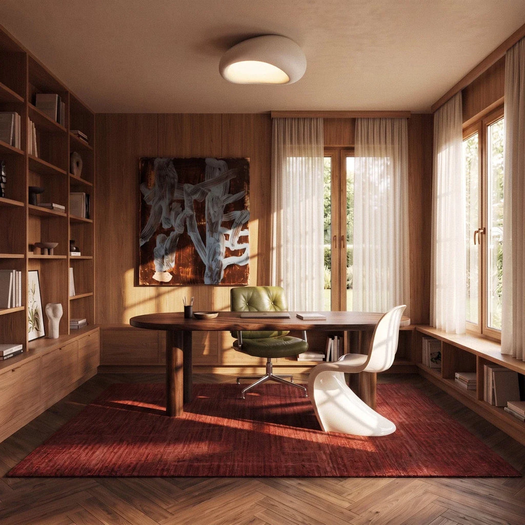 Clérachic white pebble flush ceiling light above a walnut desk, green leather chair and bookshelves in a study.