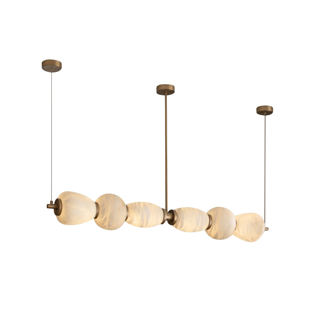 Clérachic Pebble chandelier on white, three brass drops holding the alabaster bar level.