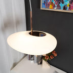 Clérachic pendant hardware seen from another angle, with the same abstract painting and rose vase nearby.