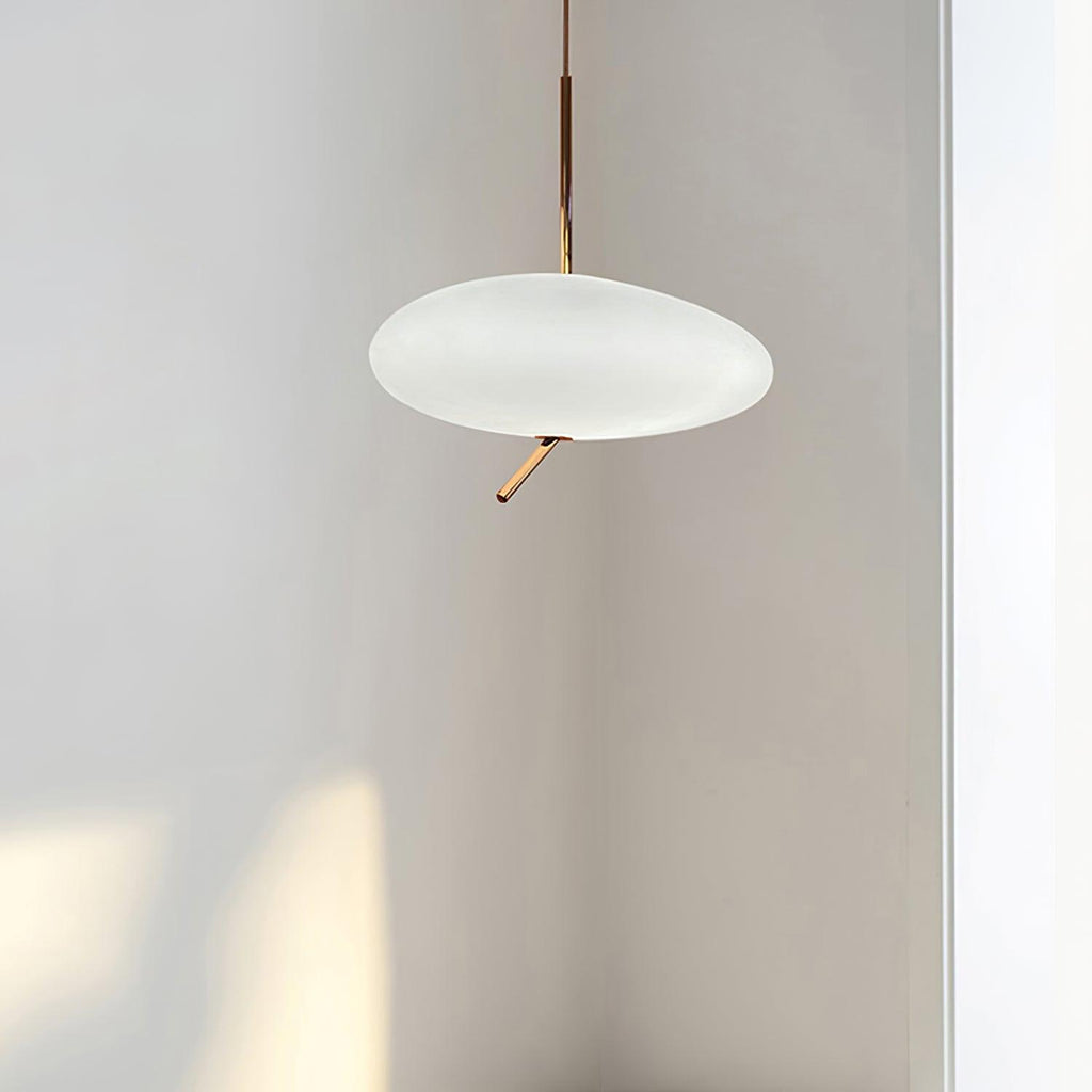 Clérachic pebble pendant photographed unlit in a plain gray studio corner, showing the frosted shade's shape.