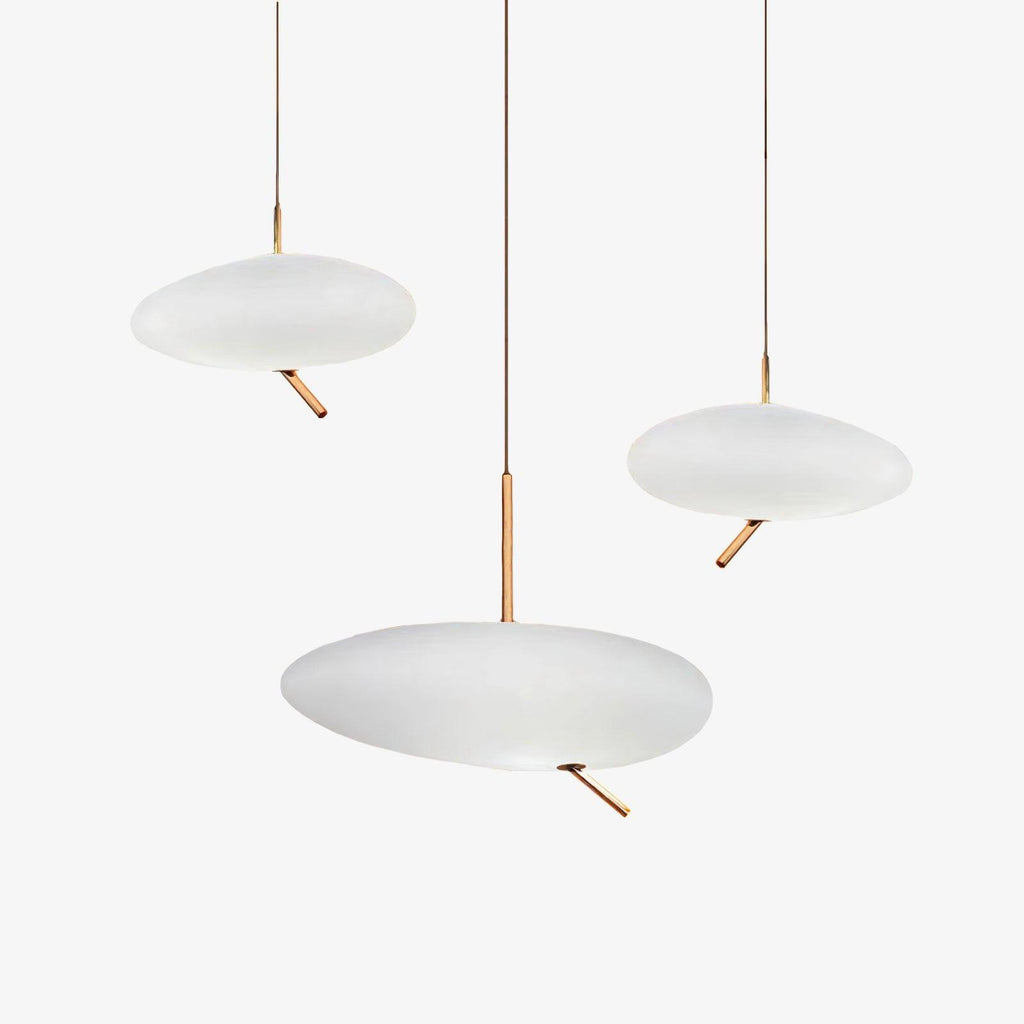 Three Clérachic pebble pendants shown unlit and grouped on white, echoing the trio's staggered arrangement.