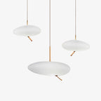 Three Clérachic pebble pendants shown unlit and grouped on white, echoing the trio's staggered arrangement.
