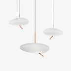 Another unlit grouping of three Clérachic pebble pendants on white, showing the rose gold stems from a different angle.