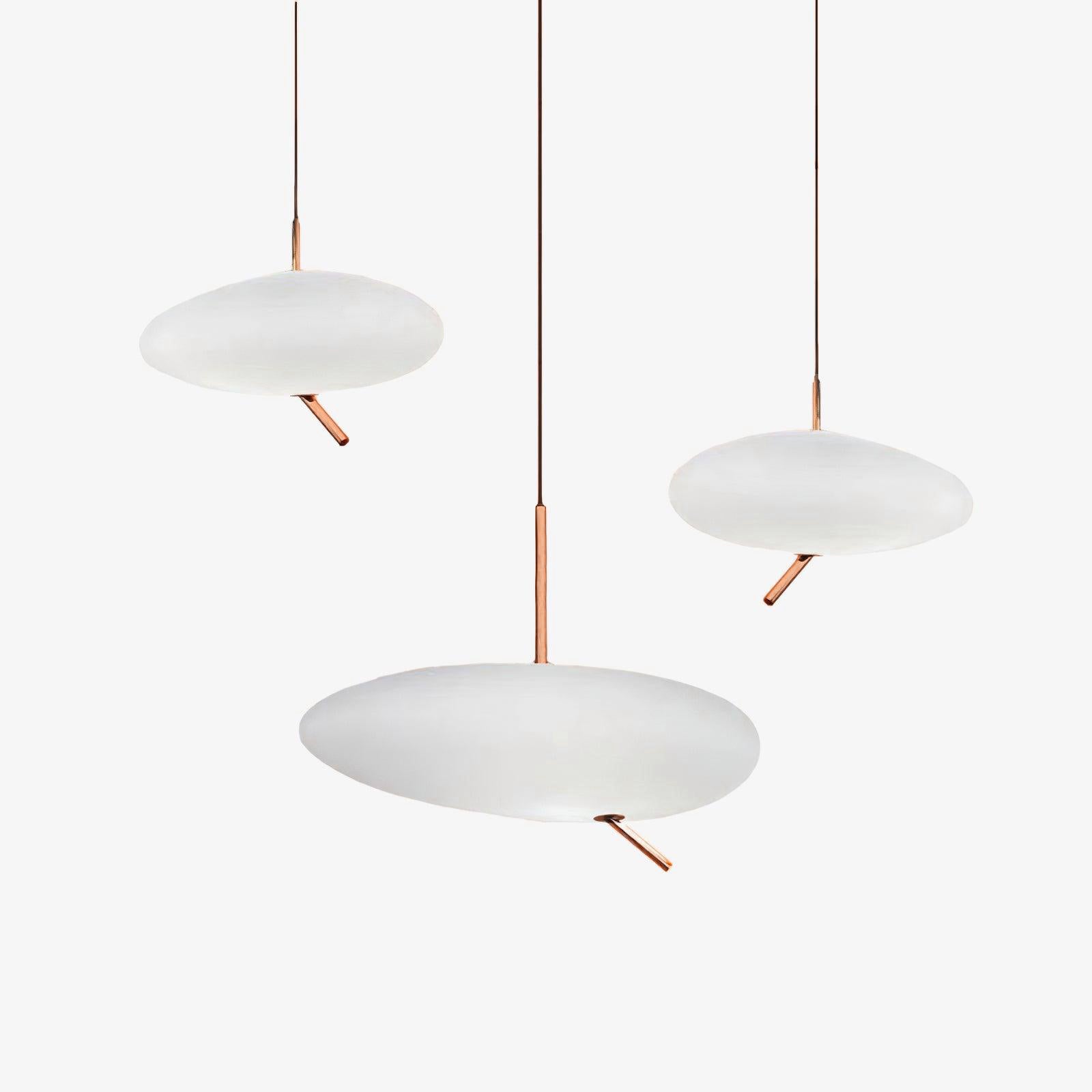 Another unlit grouping of three Clérachic pebble pendants on white, showing the rose gold stems from a different angle.