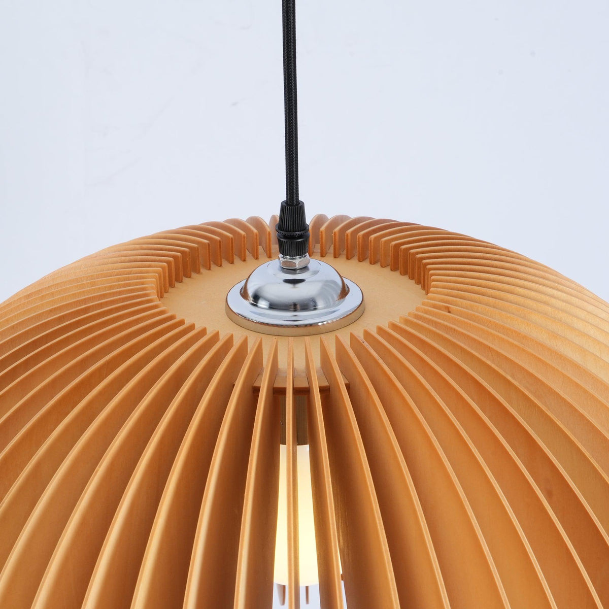 Close view of the chrome cord grip and the closely spaced slats at the crown of this Clérachic wooden pendant.