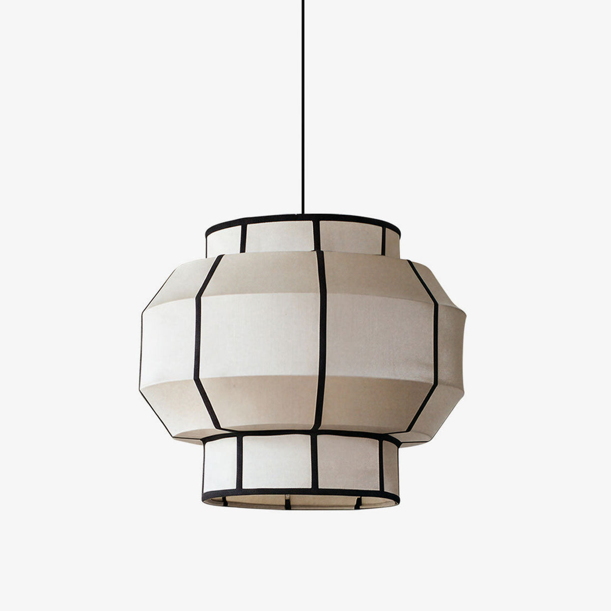 This Clérachic pendant's ribbed fabric barrel shade, black-framed, hangs against a plain white backdrop.