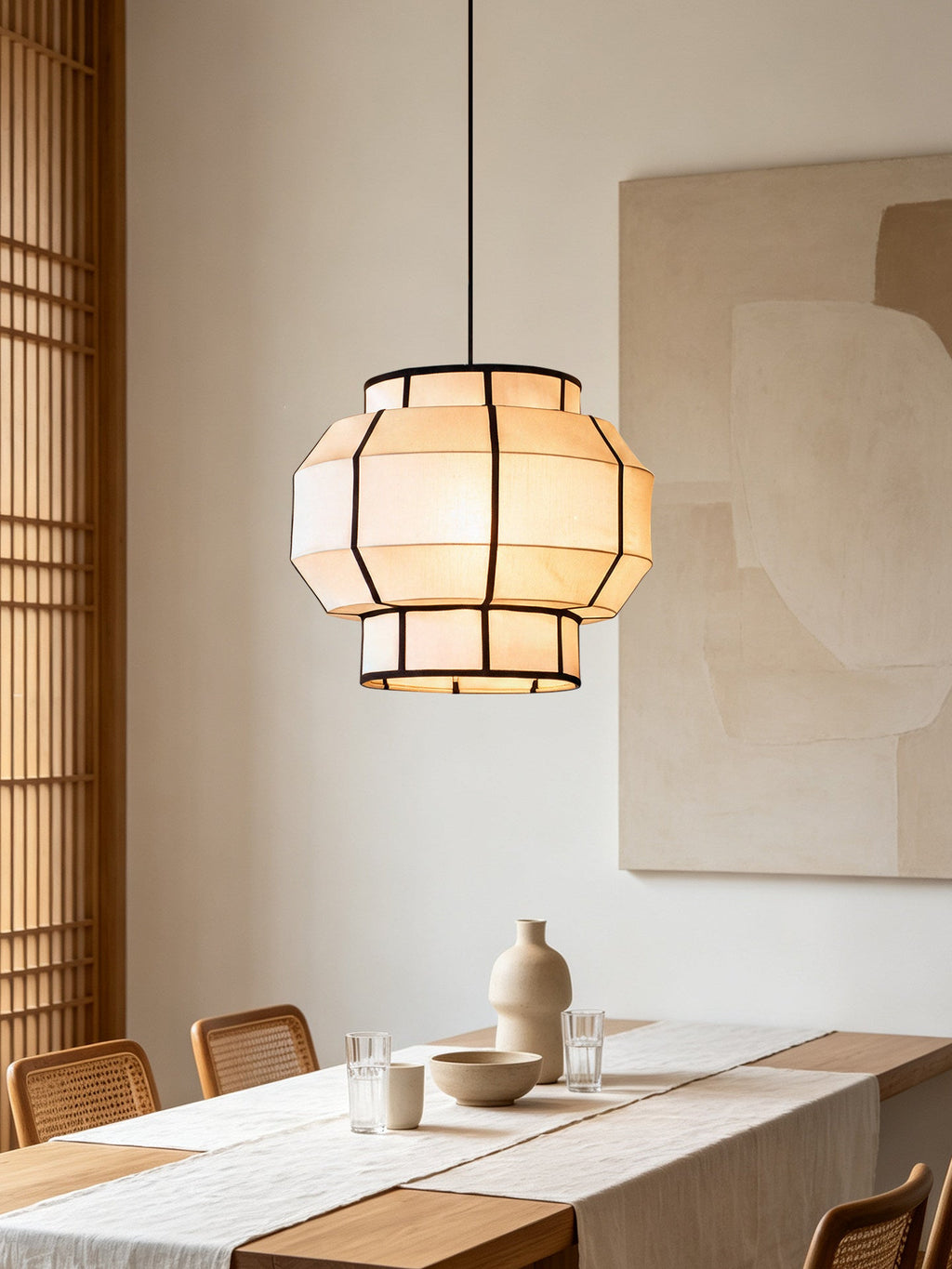 This Clérachic pendant's ribbed barrel shade lights a dining table near woven timber blinds.