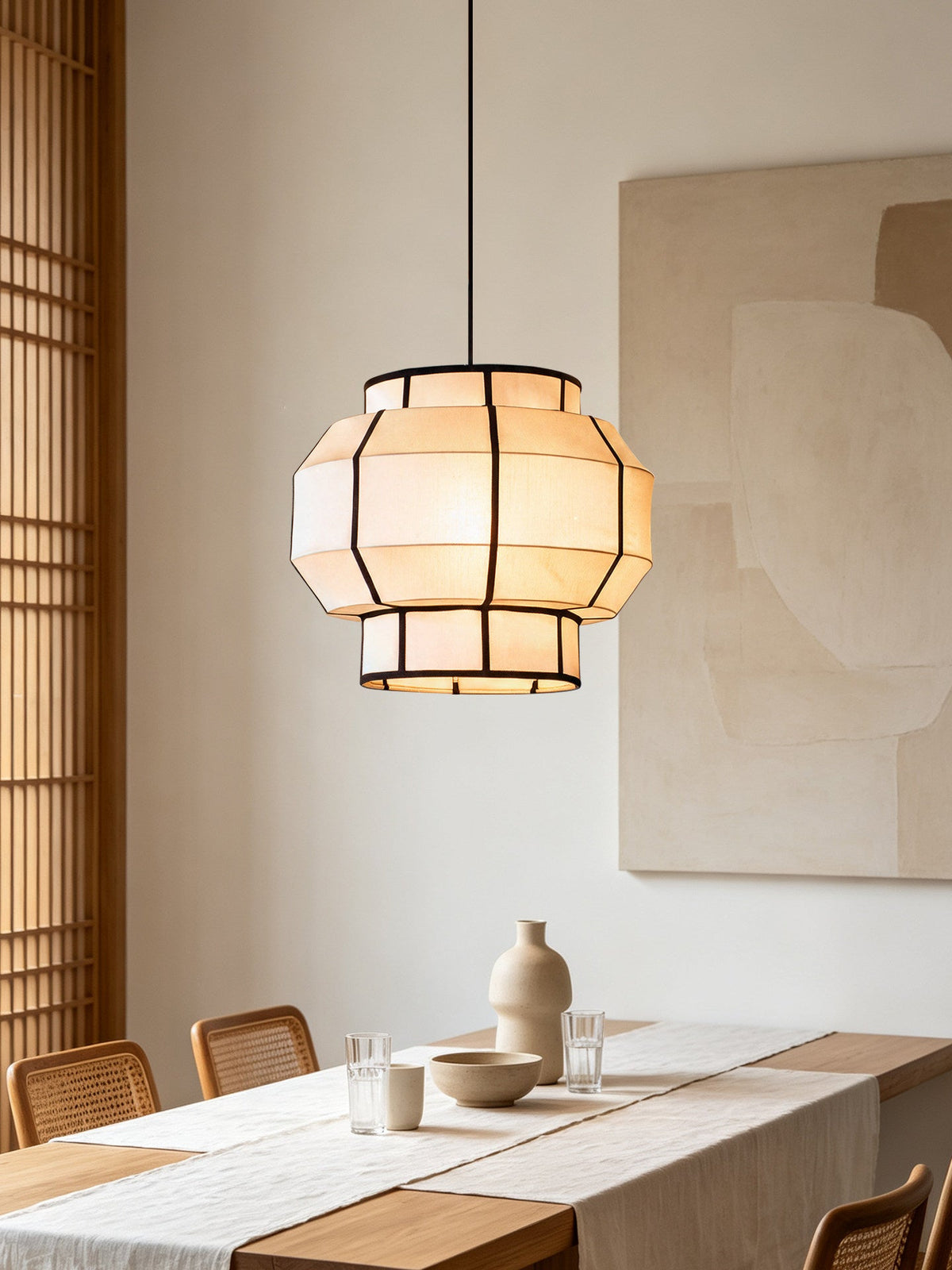 This Clérachic pendant's ribbed barrel shade lights a dining table near woven timber blinds.