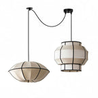 This Clérachic fixture pairs a wide dome shade with a tiered barrel shade on crossed cords.