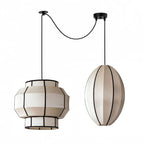 This Clérachic fixture pairs a tiered barrel shade with a vertical oval shade on crossed cords.