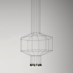 Octagonal black cable cage pendant with a cluster of light heads below, on a soft grey backdrop, from Clérachic.