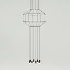 Tall cable-frame pendant with a slim cage at the top and long straight cables dropping to a cluster of lights, from Clérachic.