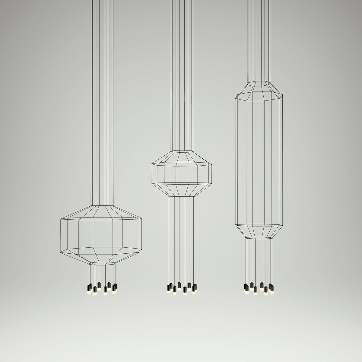 Three Clérachic wireframe pendants in different sizes, from short to tall, hung in a row on a pale studio backdrop.