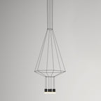 Cone-shaped black cable pendant narrowing to a hexagonal base, with four small lights, on a grey backdrop, from Clérachic.