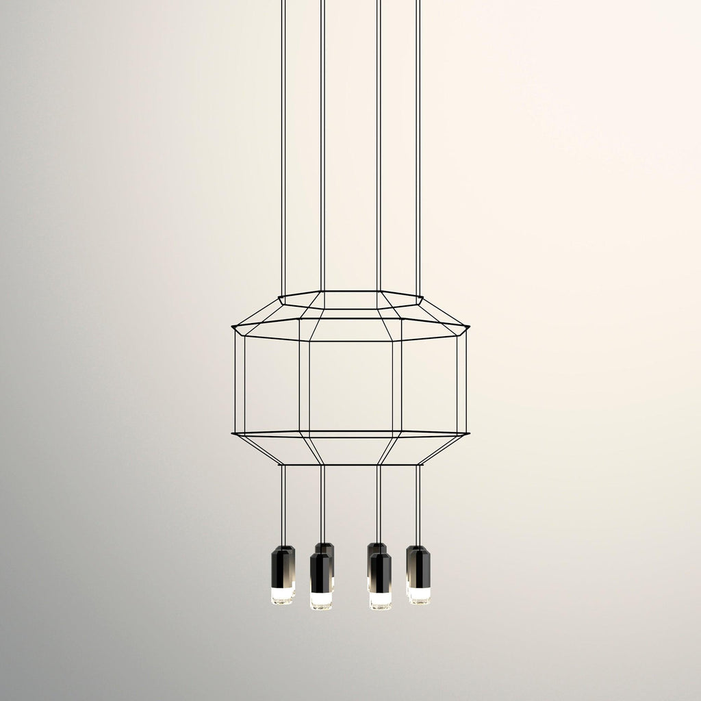 Octagonal two-tier wireframe pendant with four black light heads below, on a warm cream backdrop, from Clérachic.