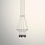 Tapered wireframe pendant with a ring at the top and several black light heads below, on a cream backdrop, from Clérachic.