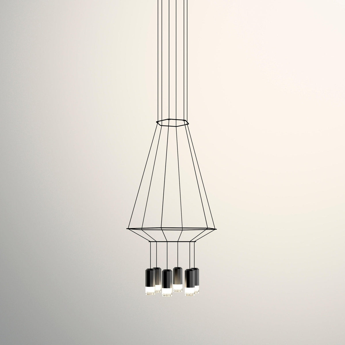 Tapered wireframe pendant with a ring at the top and several black light heads below, on a cream backdrop, from Clérachic.