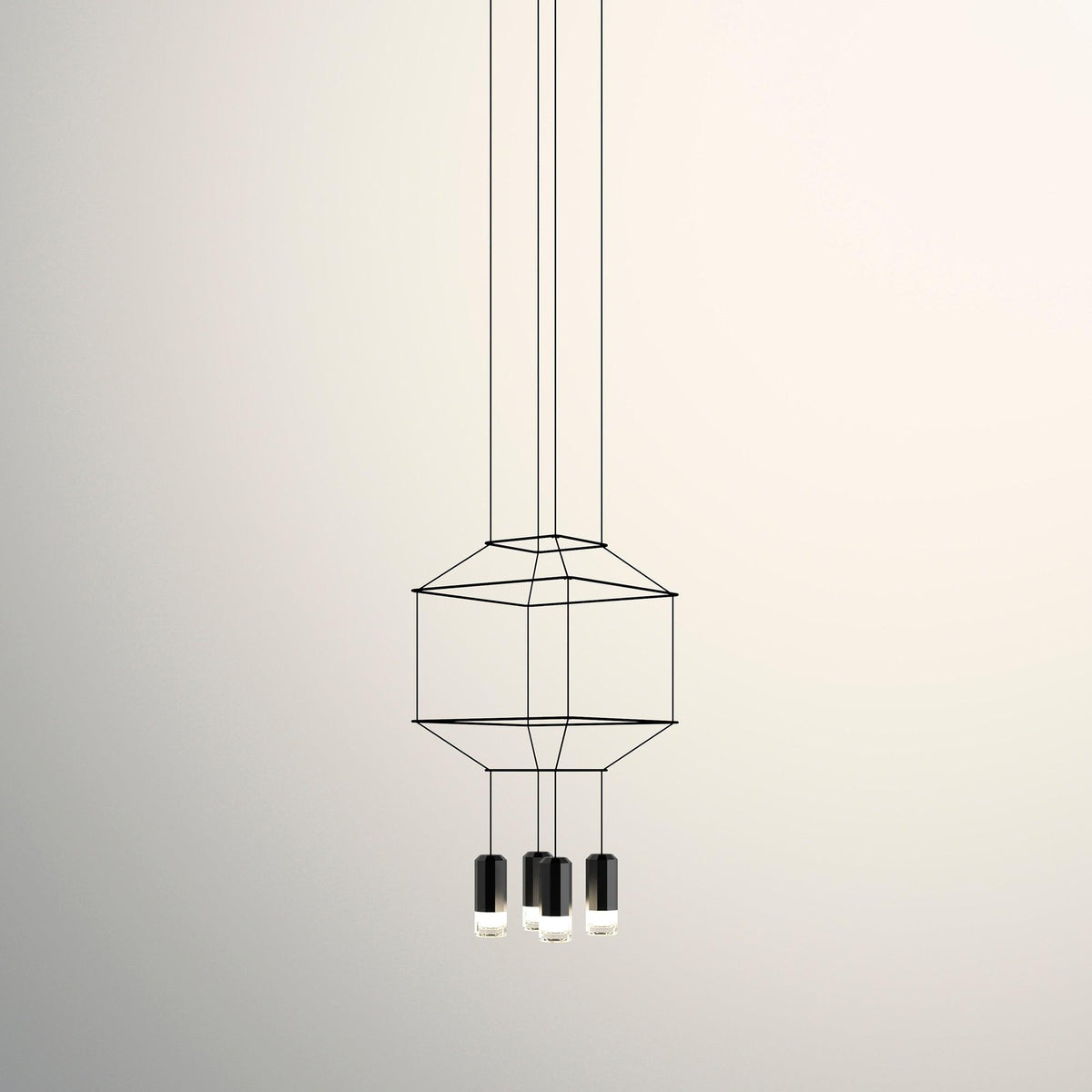 Small cable-frame pendant with a squat cage and three black light heads below, on a cream backdrop, from Clérachic.