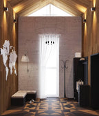 Wireframe pendant in a tall entrance hall with a pitched timber ceiling, a world map and a white curtain, from Clérachic.