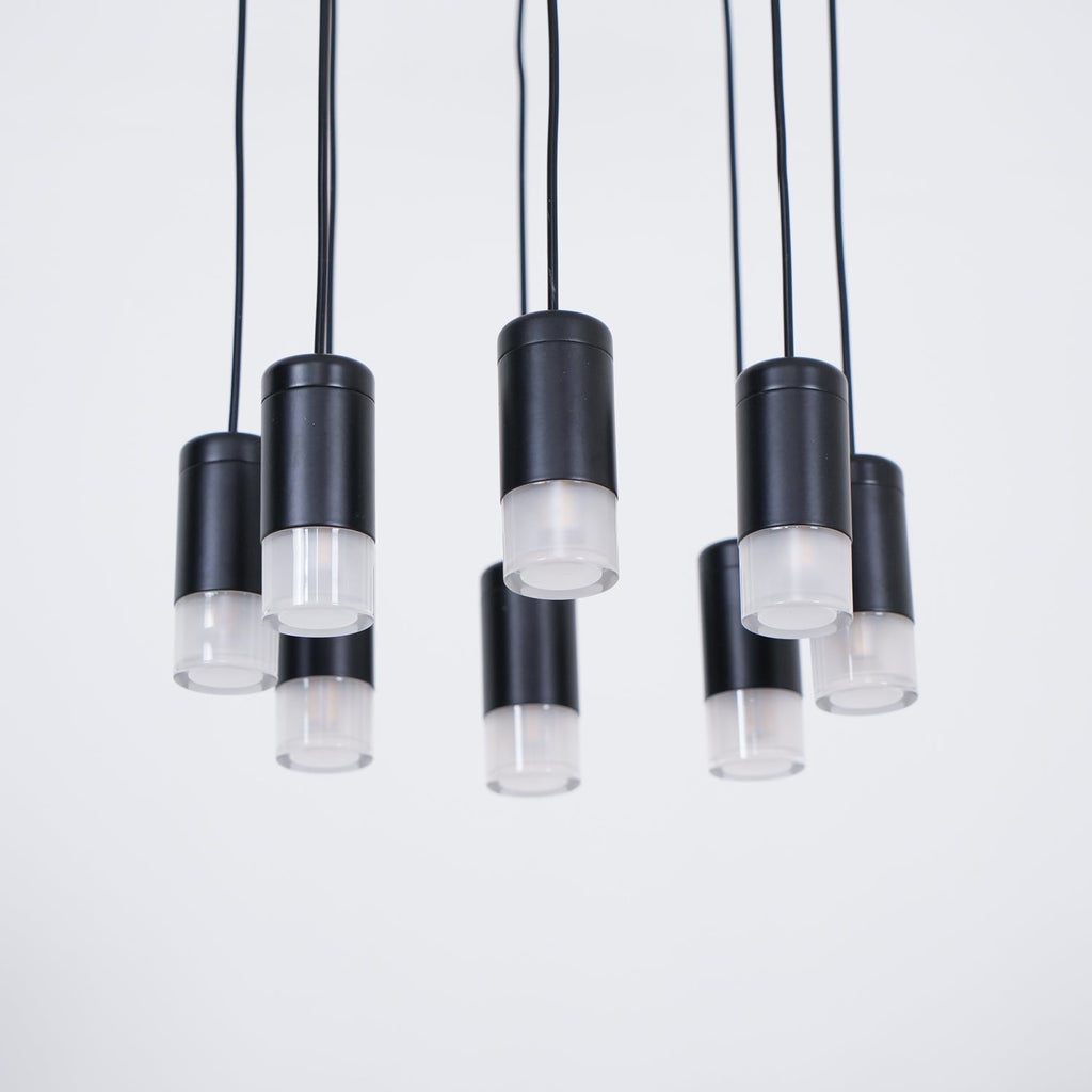 Underside view of the black light heads with frosted diffusers hanging at different lengths on this Clérachic pendant.