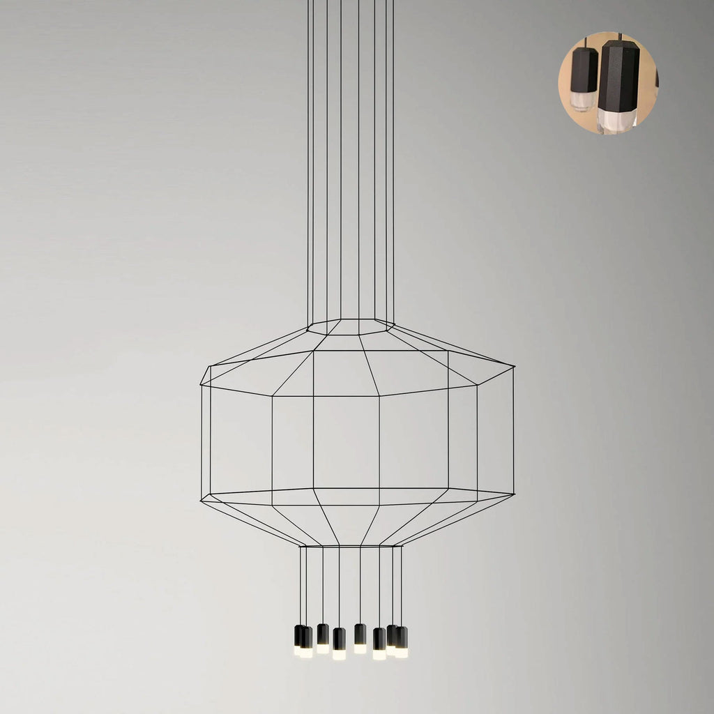 Wide octagonal wireframe pendant with a cluster of lights below, on a pale wall, with a small detail inset, from Clérachic.