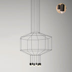 Wide octagonal wireframe pendant with a cluster of lights below, on a pale wall, with a small detail inset, from Clérachic.