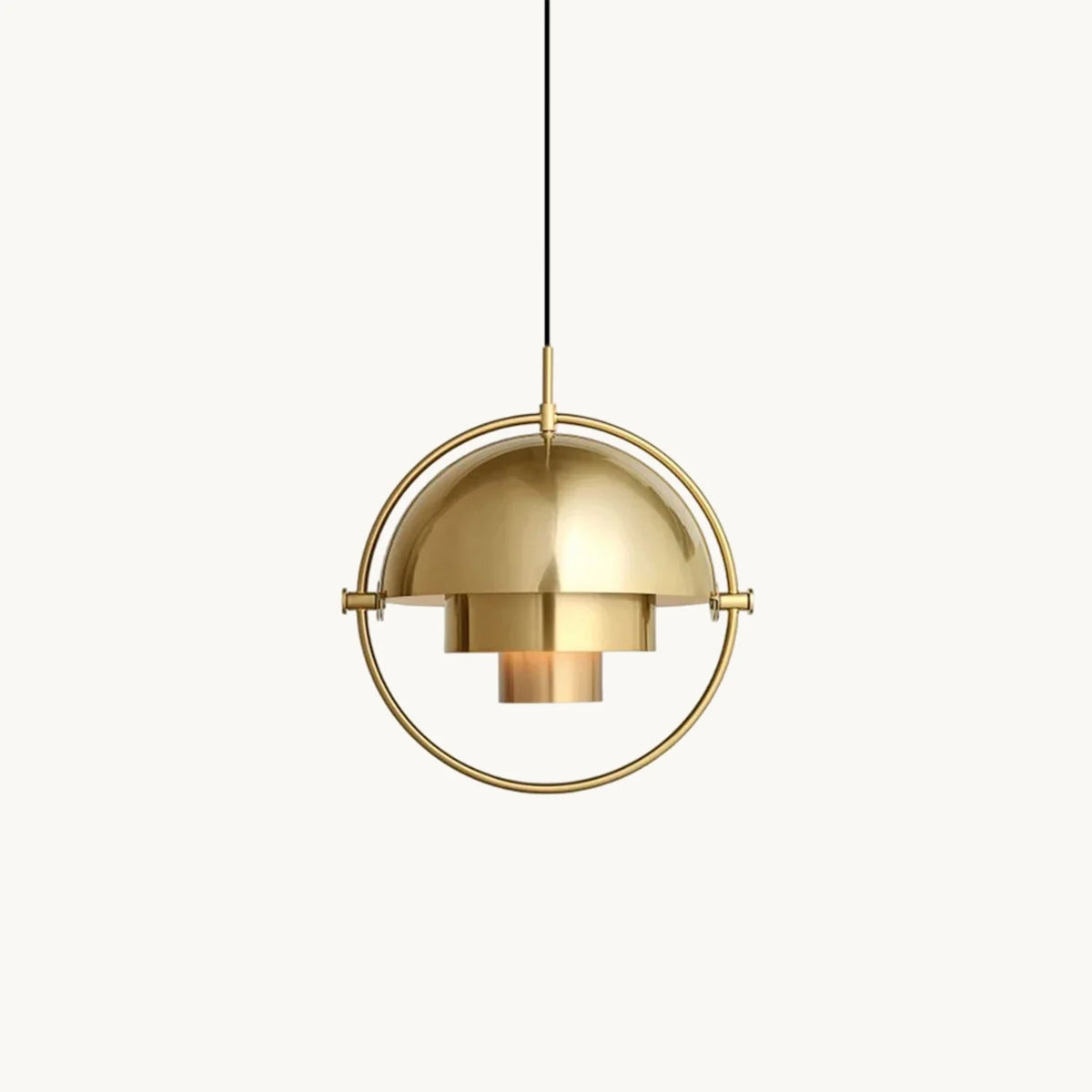 Gold-toned Clérachic pendant with a domed shade and stepped inner cylinders, held in a round frame, on a plain white backdrop.