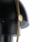 Close view of the brass adjusting knob on the gold ring of this black Clérachic pendant.