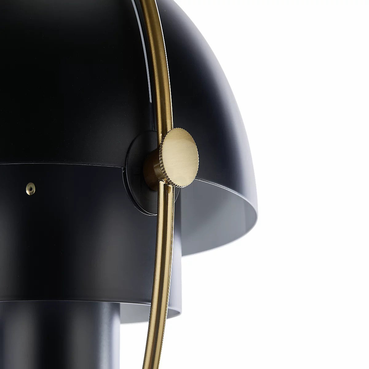 Close view of the brass adjusting knob on the gold ring of this black Clérachic pendant.