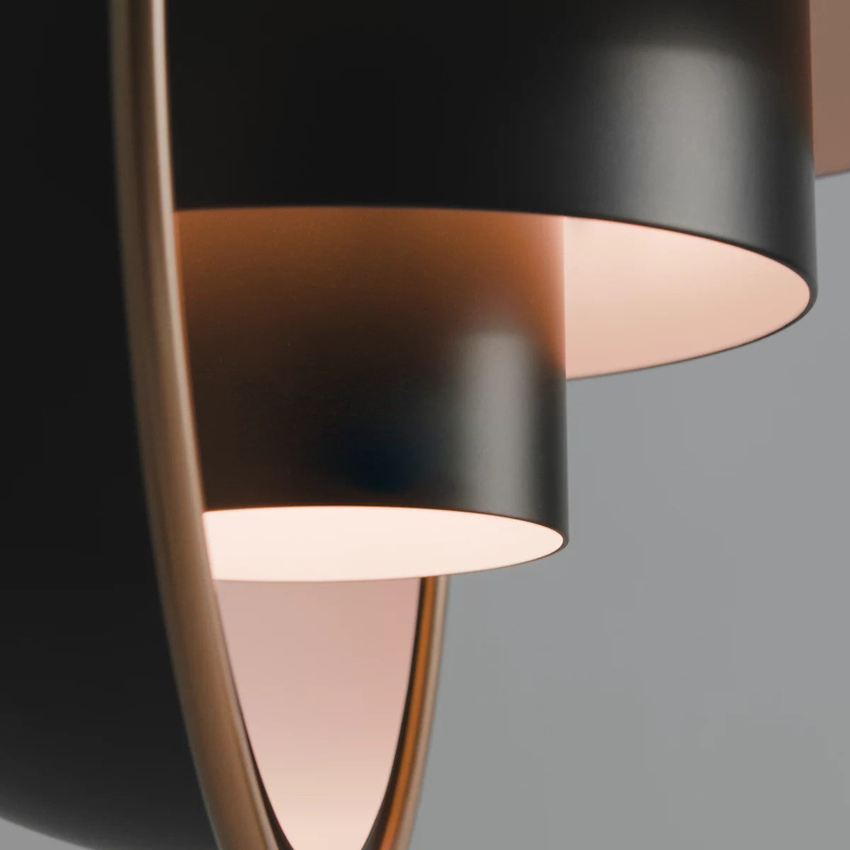 Close view of the stepped inner layers of a black Clérachic pendant, with a warm pink inside and a thin gold ring.