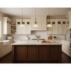 Three Clérachic pendants in a row above a dark wood island in a white kitchen with a farmhouse sink.