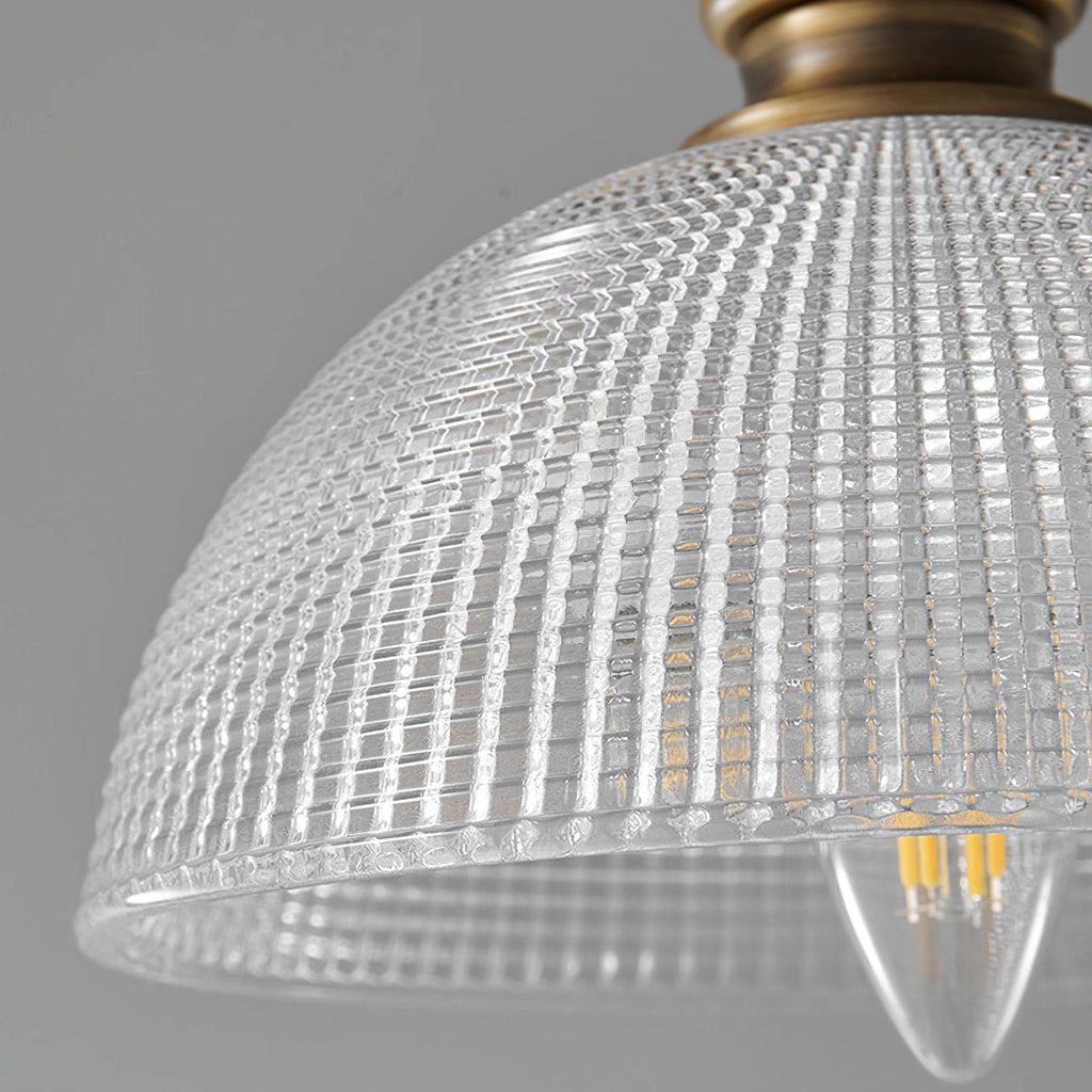 Close view of the ribbed glass dome on this Clérachic pendant, showing a candle-shaped filament bulb inside.